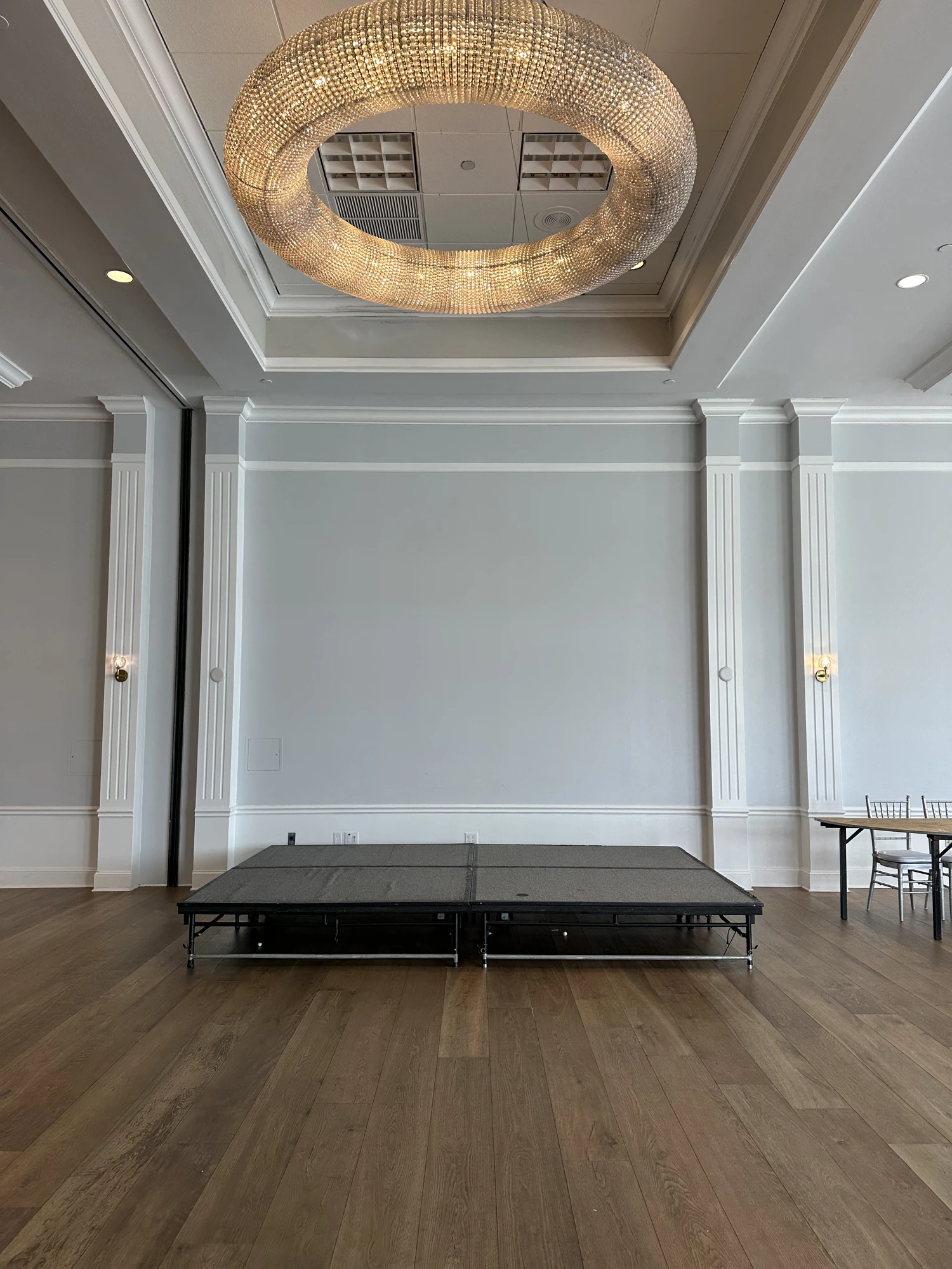 Before — a bare black event stage in the ballroom